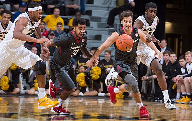 Missouri's Russell Woods, Arkansas' Anton Beard, second from left, and Dusty Hannahs and Missouri's Namon Wright race to a loose ball during the second half of an NCAA college basketball game, Tuesday, Jan. 12, 2016, in Columbia, Mo. Arkansas won the game 94-61. 