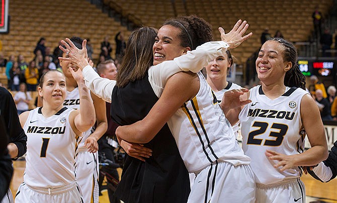 Missouri coach Robin Pingeton, center, is hugged by Cierra Porter as Juanita Robinson (23) and Lianna Doty (1) celebrate after Missouri defeated Mississippi State 66-54 in an NCAA college basketball game, Thursday, Jan. 14, 2016, in Columbia, Mo.
