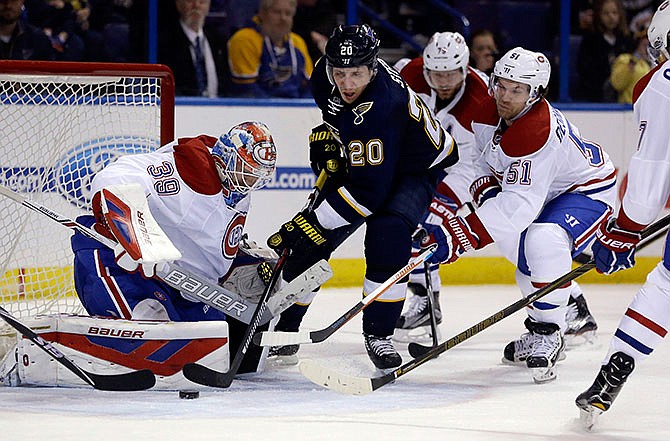 St. Louis Blues' Alexander Steen (20) tries to get off a shot as Montreal Canadiens goalie Mike Condon, left, and David Desharnais (51) defend during the second period of an NHL hockey game Saturday, Jan. 16, 2016, in St. Louis. 