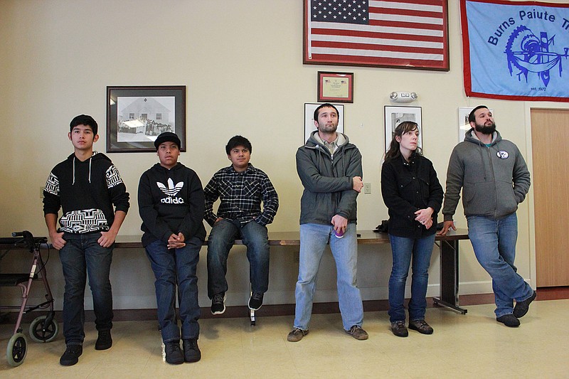 In this Wednesday, Jan. 6, 2016, file photo, members of the Burns Paiute tribe watch a news conference held by their leaders in response to the armed occupation of the nearby Malheur National Wildlife Refuge in Burns, Ore. A leader of the Oregon Indian tribe whose ancestral property is being occupied by an armed group opposed to federal land policy said Wednesday that the group is not welcome and needs to leave.