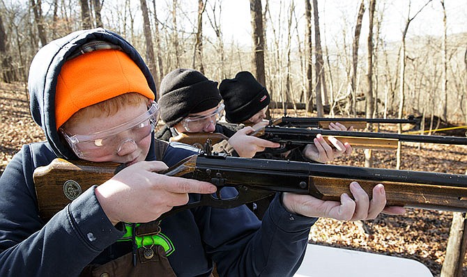 From left, Garrett Hentges, Jacob Ehmke and Cole Patterson, all of Scout Troop 12 in St. Martins, level their
BB guns Saturday at Camp Hohn at the Lake of the Ozarks Scout Reservation during the annual Five Rivers District
Klondike Derby.