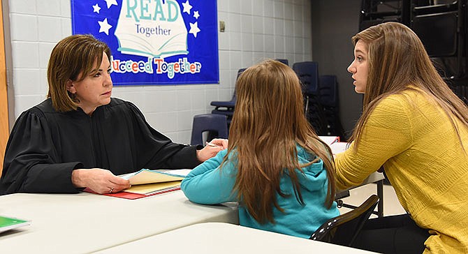 Counselor Samantha Cassmeyer, right, tells of the improvements made by a student to Judge Mary Russell, at left, who works with students at Jefferson City's Lewis and Clark Middle School during Thursday's "Blazer Court." Russell, a justice on the Missouri Supreme Court, has worked with the school and students for several years to offer positive reinforcement when students' behavior, attendance and/or grades improve. She's also there to tell them that as middle school students, they are moving into adulthood, and as such, they have to be responsible for their actions