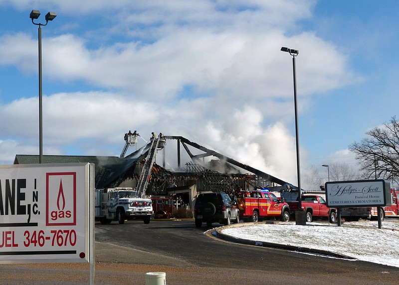 At 1 p.m. Sunday, firefighters from several Lake Area fire departments continue to battle a blaze that destroyed the Hedges-Scott Funeral Home on South Business Missouri 5 in Camdenton. 