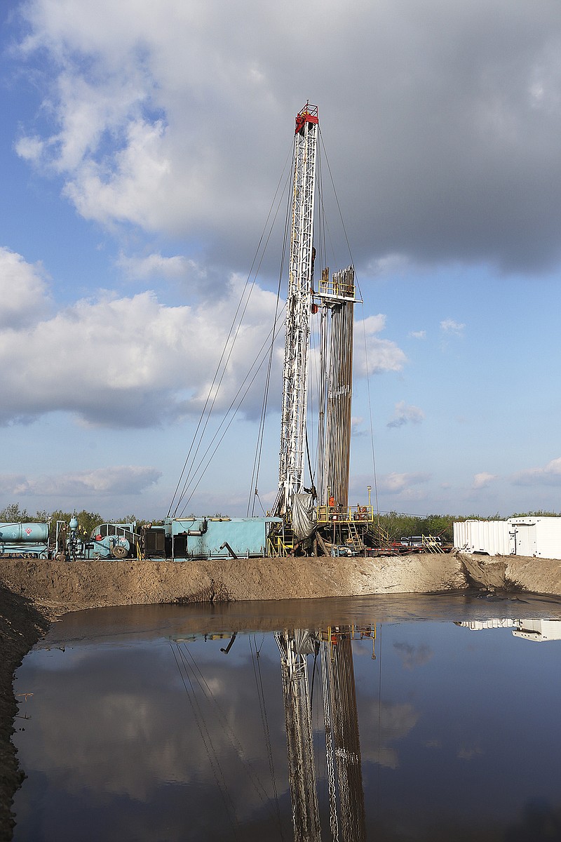 In this Wednesday, Nov. 11, 2015 photo, a Price Drilling rig stands still after reaching total depth at a rig located on a ranch owned by Richard Collier in Zavala County, Texas. The area is in the edge of the Eagle Ford Shale which seen a decrease in activity due to the low oil prices. Collier owns a company that sells pipe to drilling companies and his business has also been affected.