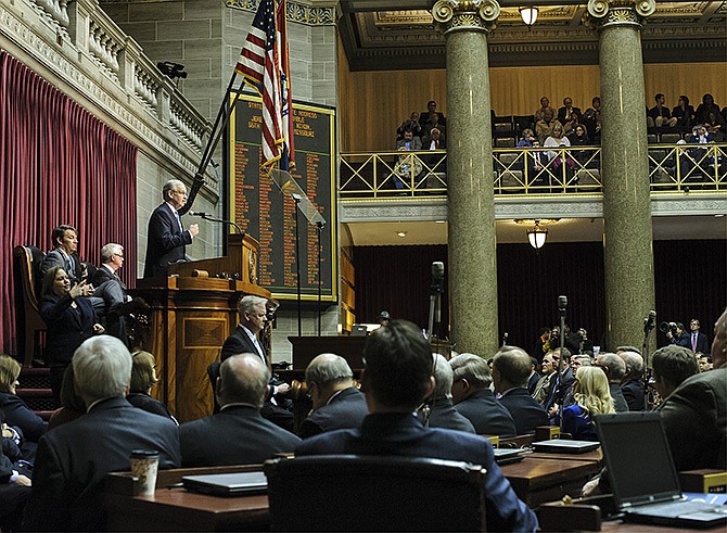 Gov. Jay Nixon stands atop the dais and addresses members of the Missouri Legislature as well as other guests and visitors filling the House of Representatives gallery during the annual State of the State address on Wednesday.