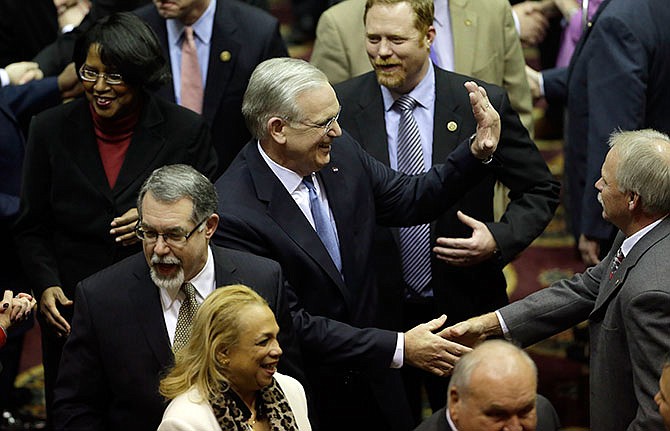 Missouri Gov. Jay Nixon greets lawmakers as he enters the House chamber to deliver the annual State of the State address before a joint session of the House and Senate, Wednesday, Jan. 20, 2016, in Jefferson City, Mo. 