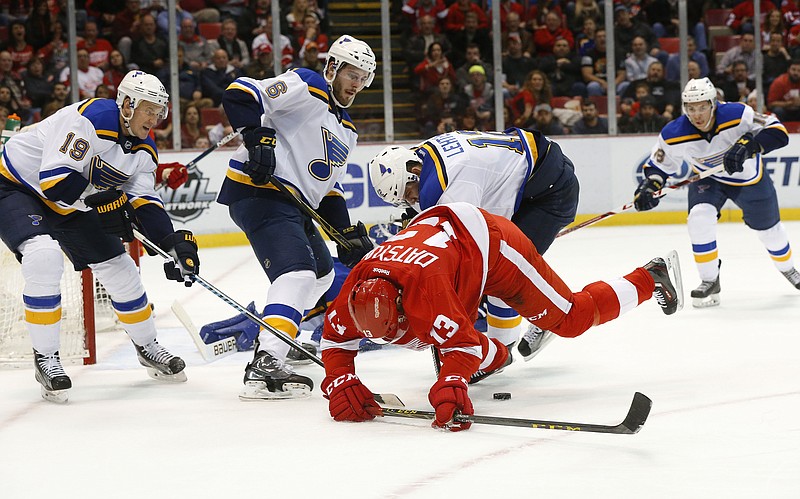 Pavel Datsyuk of the Red Wings is upended by Jori Lehtera of the Blues during the second period of Wednesday night's game in Detroit.