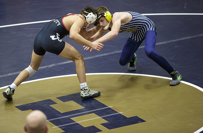 Tanner Irwin of Jefferson City and Nick Schnieders of Helias square off in a 138-pound match Wednesday night at Rackers Fieldhouse.