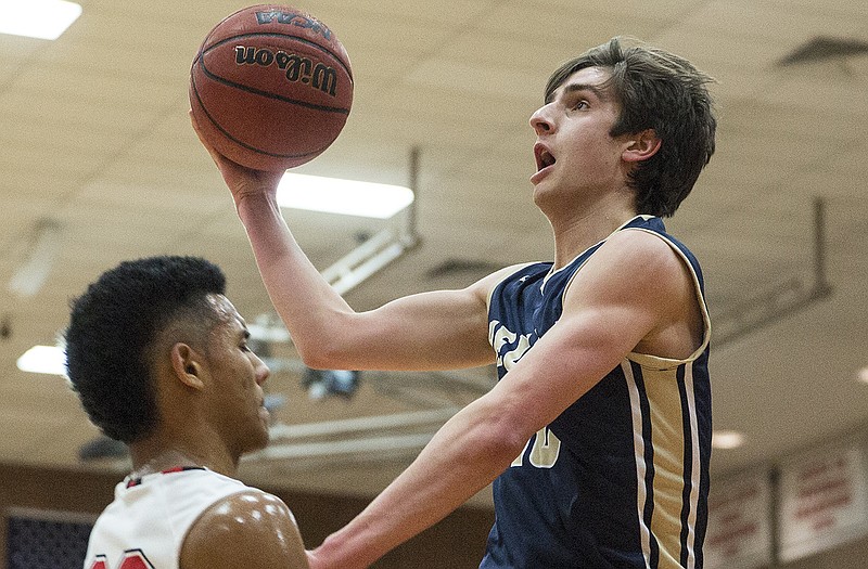 Sam Husting of Helias prepares to put a shot up against the defense of Rhylin Spence of the Jays during Thursday night's game at Fleming Fieldhouse.