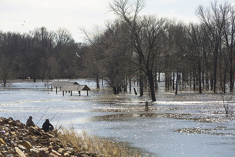 Keith White and David Jones fish downstream from the Millwood State Park spillway on Friday, Jan. 22, 2016. Some boat launches are closed because of flooding. They are opening as they are deemed safe, officials said.