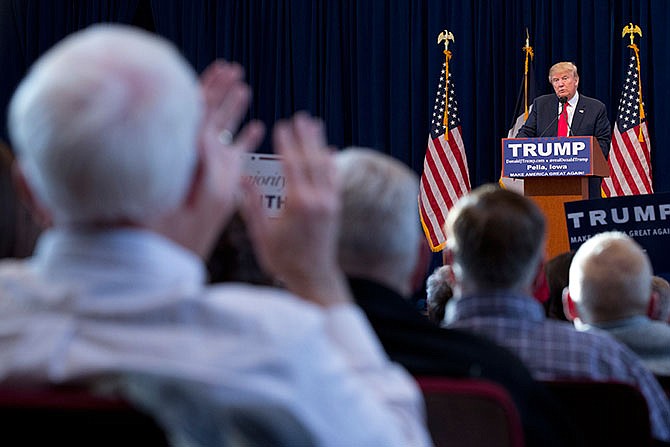 A supporter claps as Republican presidential candidate Donald Trump speaks during a campaign event at Central College, Saturday, Jan. 23, 2016, in Pella, Iowa.