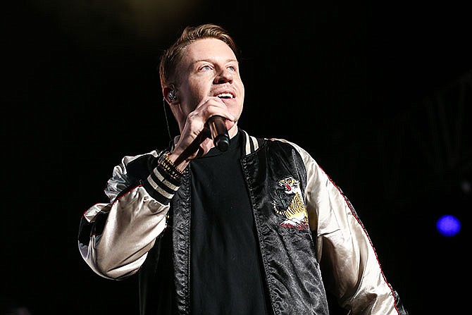 In this Dec. 4, 2015 file photo, Macklemore performs on stage at Power 106's Cali Christmas 2015 in Inglewood, Calif. Macklemore explores racism and hip-hop in a new song called "White Privilege II," rapping about a white person's position in society with black people fighting injustice. (Photo by John Salangsang/Invision/AP, File)