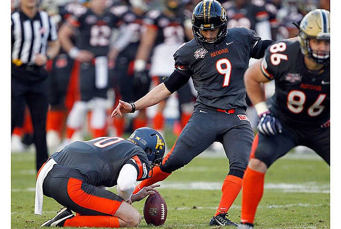 National team's Andrew Baggett, of Missouri, kicks a 42-yard field goal as Nick O'Toole (10), of West Virginia, holds during the first half of the NFLPA Collegiate Bowl football game in Carson, Calif., Saturday, Jan. 23, 2016. Baggett kicked six field goals as the Nationals won 18-17.