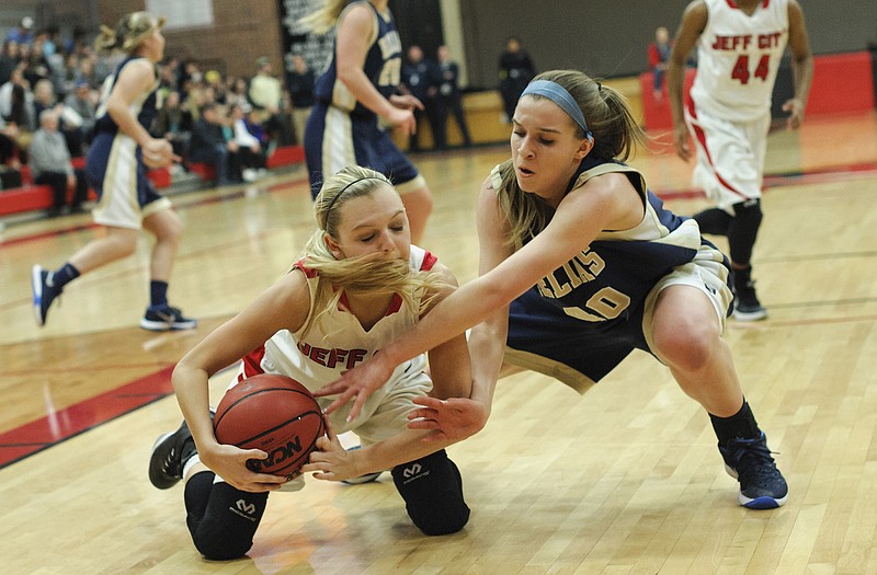 Lexy Haug of Jefferson City and Ellie Rockers of Helias battle for a loose ball in the first half of Monday night's game at Fleming Fieldhouse.