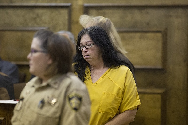 Tracie Dierks, 41, is led into a Little River County courtroom Tuesday, Jan. 26, 2016. Dierks is in custody in connection with the fatal shooting of Caitlin Caskey, 17, at a birthday party in the community of Wallace on Saturday, Jan. 24, 2016.