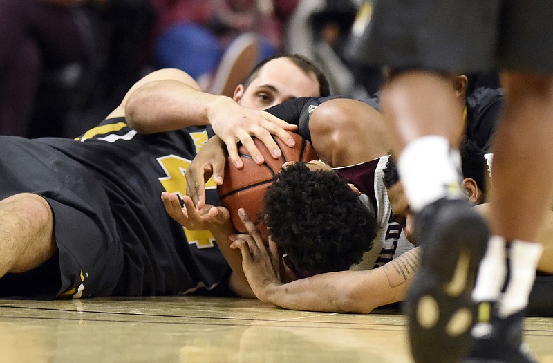 Ryan Rosburg of Missouri battles with Admon Gilder of Texas A&M for a loose ball during Saturday afternoon's game in College Station, Texas.