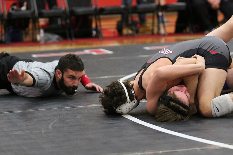 Tanner Irwin of Jefferson City puts Wyatt Shaw of Hickman on the mat during their 132-pound match Tuesday night at Fleming Fieldhouse.