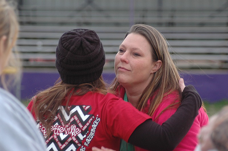 Shanna VanArsdall hugs a friend of shooting victim Caitlin Caskey after a vigil late Tuesday, Jan. 26, 2016, afternoon at Dick Hays Stadium at Ashdown High School. The vigil honored the memory of Caitlin, who was fatally shot Saturday night during a birthday party at a house in the Wallace community in Little River County, Ark.