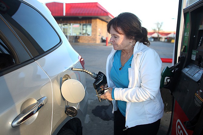 Deborah Lenger fills up her car with gas Thursday at the Conoco on Eastland Drive. 