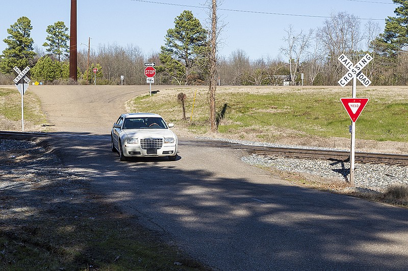 A driver crosses the train tracks Wednesday, Jan. 27, 2016 where a fatal collision between a car and a train occurred Jan. 24 in Ogden, Ark. Two people died and one woman is still in the hospital.