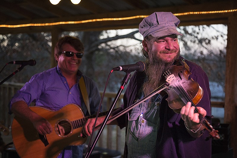 James Garrett, right, a tribute band artist who performs in Branson, Mo., warms up with his bandmate Shawn Pittman on Saturday, Jan. 30, 2016 at Ramage Farms in Hooks, Texas. The concert was in honor of Manna Kitchen's 20th year.