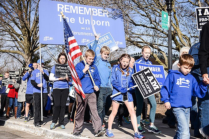 Supporters walk the Missouri State Capitol sidewalks while passionately chanting their pro-life message at the 2016 Midwest March for Life.