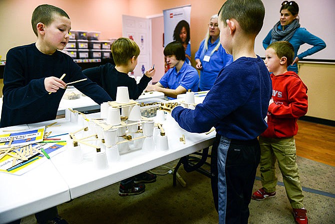 
Micah Vecellio, 10, left, grabs popsicle sticks to stack on his tower as his brother, Noah, 8, front right, organizes white cups at the base Saturday at LabSpace Robotics in Jefferson City.
