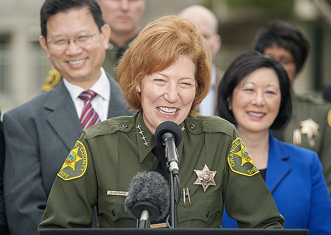 Orange County Sheriff Sandra Hutchens is all smiles Saturday as she answers questions about the capture of both outstanding jail escapees, Hossein Nayeri and Jonathan Tieu, during a news conference outside Orange County Sheriff's Department headquarters in Santa Ana, California.