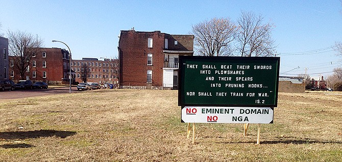 This photo shows a vacant lot and a sign placed there by opponents of a proposed site of the National Geospatial-Intelligence Agency's new regional headquarters in north St. Louis. St. Louis is competing with adjacent St. Clair County in Illinois, which has offered nearly 400 acres of donated land near Scott Air Force Base to the defense and intelligence agency, a combat support branch of the Department of Defense. 