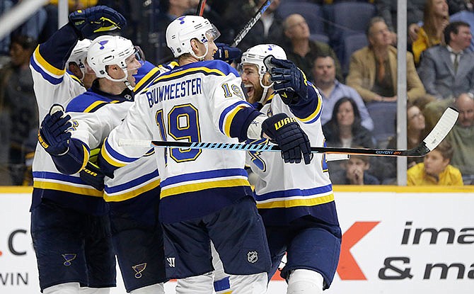 St. Louis Blues right wing Troy Brouwer, second from left, celebrates with Jay Bouwmeester (19) and Alex Pietrangelo, right, after Brouwer tipped in a shot by Pietrangelo for a goal against the Nashville Predators in the third period of an NHL hockey game Tuesday, Feb. 2, 2016, in Nashville, Tenn. The goal gave the Blues a 1-0 win. 
