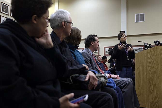 Joyce Gold, right, speaks during a city council meeting Tuesday, Feb. 2, 2016, in Ferguson, Mo. Ferguson city leaders have spent months negotiating a settlement with the U.S. Department of Justice, a plan that calls for sweeping changes to police practices in the St. Louis suburb where 18-year-old Michael Brown was fatally shot. 