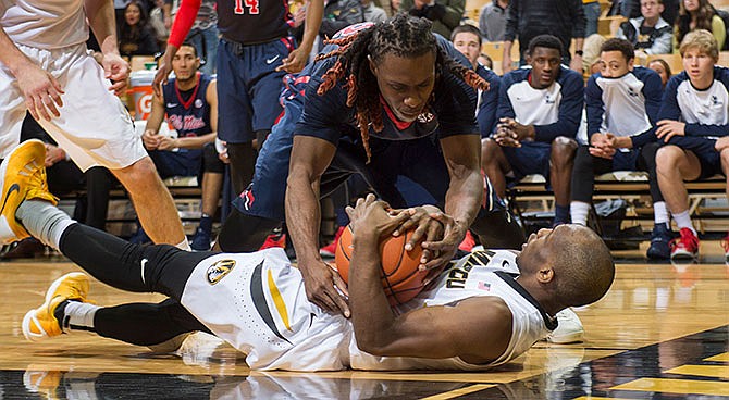 Mississippi's Stefan Moody, top, tries to wrestle the ball away from Missouri's Terrence Phillips during the second half of an NCAA college basketball game Wednesday, Feb. 3, 2016, in Columbia, Mo. Mississippi won 76-73.