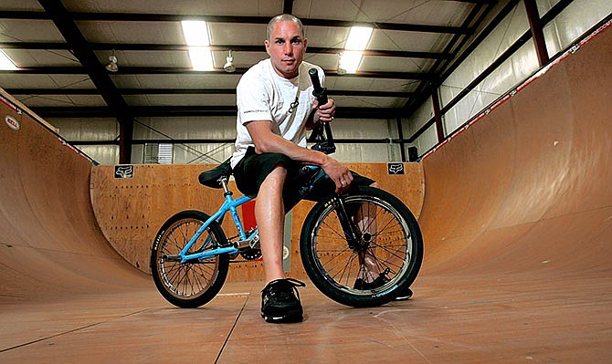 In a Friday, June 24, 2005 file photo, X-Games athlete Dave Mirra poses in the half-pipe at his training facility in Greenville, N.C. Police say veteran X Games biker Dave Mirra has died in North Carolina. Greenville police said Thursday, Feb. 4, 2016, that Mirra's body was found earlier in the day with an apparently self-inflicted gunshot wound. He was 41.