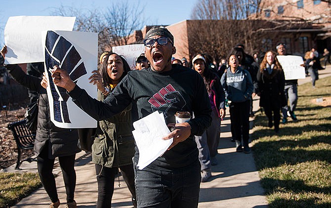 University of Missouri senior and Concerned Student 1950 member Kendrick Washington, front, chants and marches with others after interrupting a Board of Curators meeting Thursday, Feb. 4, 2016 on the way to the student center, in Columbia, Mo. The group read a list of demands for improvements in diversity and expressed their support for professor Melissa Click. (Daniel Brenner/Columbia Daily Tribune via AP)