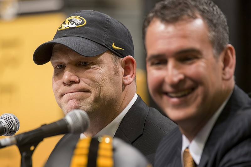 Missouri head football coach Barry Odom listens while athletic director Mack Rhoades laughs after Odom was announced as the new head football coach of the Tigers last December at Mizzou Arena.