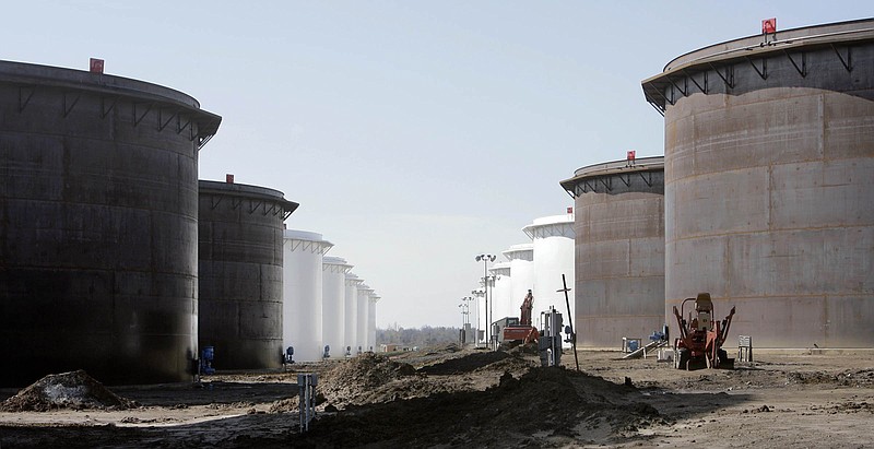 This March 13, 2012, photo shows older and newly constructed 250,000 barrel capacity oil storage tanks at the SemCrude tank farm north of Cushing, Okla. For the past seven weeks, the United States has been producing and importing an average of 1 million more barrels of oil every day than it is consuming. That extra crude is flowing into storage tanks, especially at the country's main trading hub in Cushing, pushing U.S. supplies to their highest point in at least 80 years, the Energy Department reported Wednesday, Feb. 25, 2015.