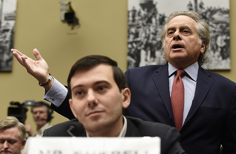 Benjamin Brafman, right, attorney for pharmaceutical chief Martin Shkreli, foreground, speaks on Capitol Hill.