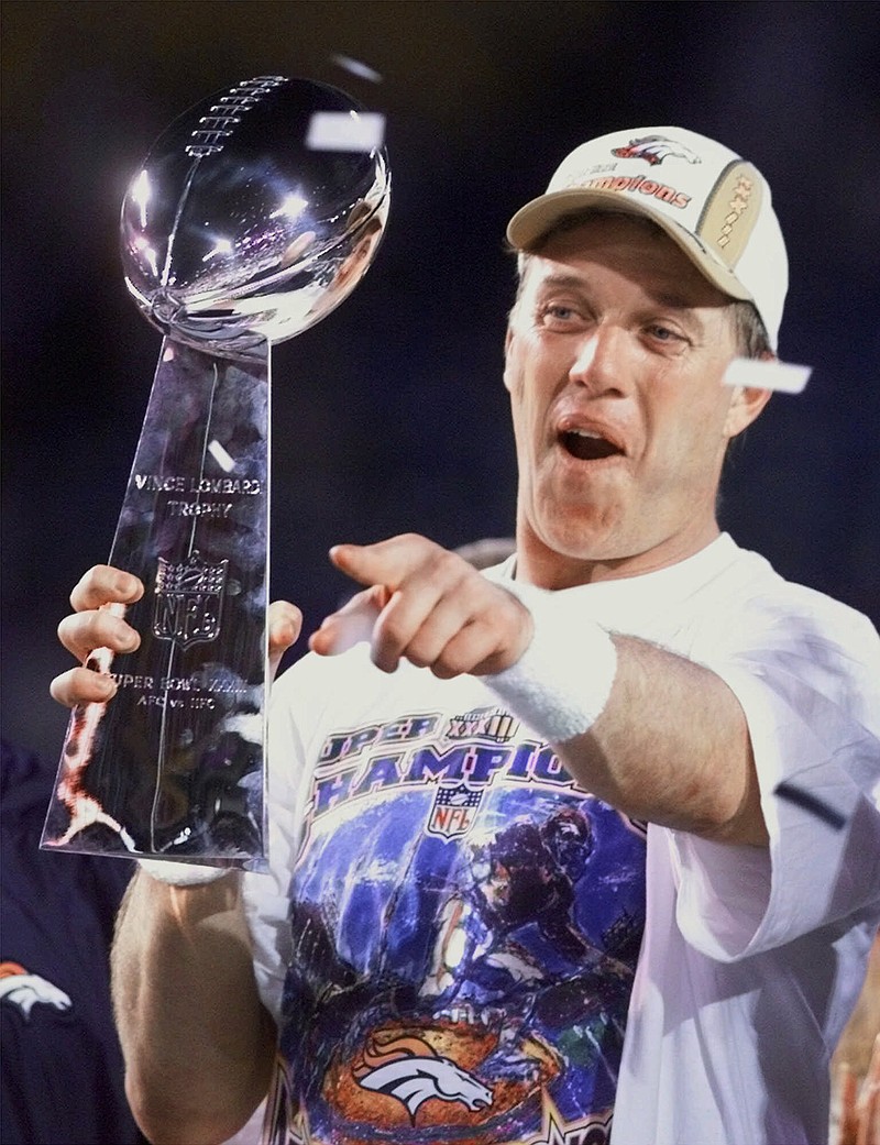  In this Jan. 31, 1999, file photo, Denver Broncos quarterback John Elway celebrates the Broncos 34-19 win over the Atlanta Falcons in Super Bowl XXXIII in Miami. Elway is one of the very few to say he won it all, then simply walked away. Now, Peyton Manning is trying to follow in Elway's footsteps, wearing the same Broncos uniform Elway wore when he walked off into the sunset nearly 20 years ago.
