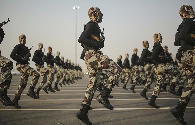In this Thursday, Sept. 17, 2015 file photo, Saudi security forces take part in a military parade in preparation for the annual Hajj pilgrimage in Mecca, Saudi Arabia. Saudi Arabia's military spokesman said Thursday, Feb. 4, 2016 that the kingdom is ready to send ground troops to Syria to fight Islamic State group if coalition leaders agree during an upcoming meeting in Brussels.