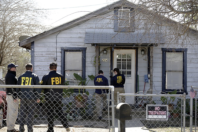 FBI agents gather outside the home of Crystal City, Texas Mayor Ricardo Lopez for his arrest on Thursday morning, Feb. 4, 2016. Almost every top official in the remote South Texas town was arrested Thursday under a federal indictment accusing them of taking bribes from contractors and sending city workers to help an illegal gambling operator nicknamed "Mr. T."