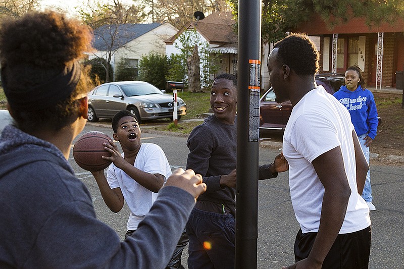 Miquavion Gant prepares to shoot a basket with his neighbors Friday, Feb. 5, 2015 across from Fairview Elementary School. Even with the age gap between him and his competitors, Miquavion held his own.