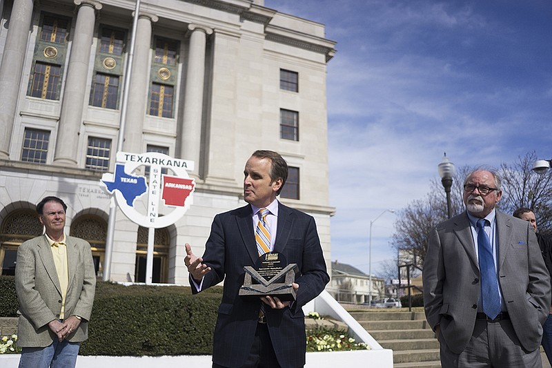 Representative of District 5 in the Texas House of Representatives Bryan Hughes, center, speaks after being awarded the visionary leadership award from the Combined Law Enforcement Association of Texas Executive Director Charley Wilkison, right, Friday, Feb. 5, 2016 in front of the Downtown Post Office.