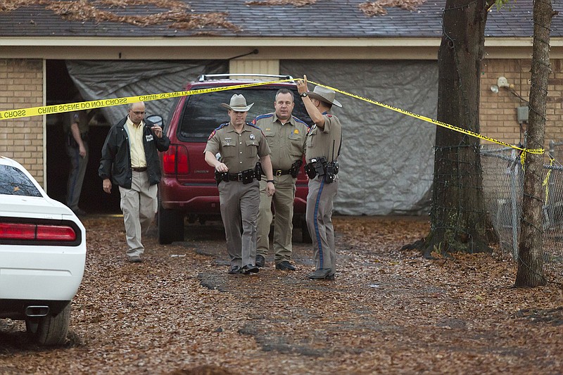 Texas Department of Public Safety troopers investigate a fatal officer-involved shooting Dec. 15, 2014 on Page Street in Texarkana, Texas. An officer with Texarkana, Texas, Police Department responded to a burglary call at the home around 2 a.m.