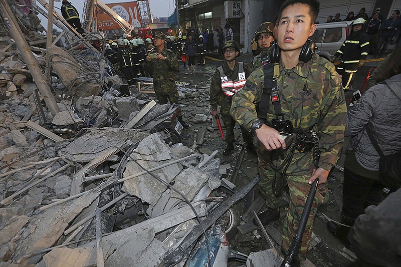 Army soldiers search a toppled building Saturday, Feb. 6, 2016 after a tremor hit in Tainan, Taiwan. The 6.4-magnitude earthquake struck early morning, toppling at least one high-rise residential building and trapping people inside. The building was 17 stories tall, and rescue crews pulled out at least 127 survivors and two bodies—a 10-day-old girl and a 40-year-old man—Taiwan's Central News Agency reported. It was unclear how many more people were still trapped inside.
