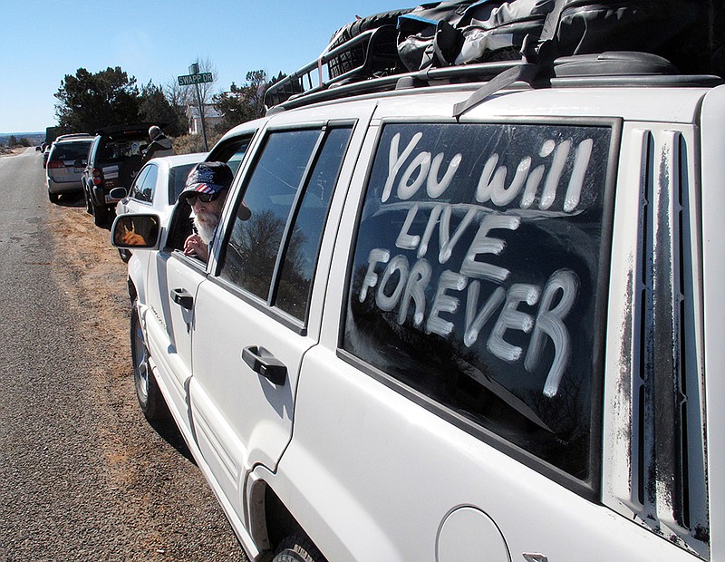 Ben Matthews, of Port Huron, Mich., awaits the funeral service for Arizona rancher Robert "LaVoy" Finicum outside a church in Kanab, Utah, on Feb. 5, 2016. Matthews says he met Finicum during a takeover of federal land in Oregon. Hundreds of people packed a Mormon church in rural Utah for the viewing ceremony for the fallen spokesman of the Oregon armed standoff. Police shot and killed Finicum during a Jan. 26 traffic stop after they say he reached for a gun. His supporters called it an ambush.