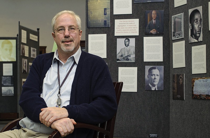 Lincoln University archivist Mark Schleer sits just outside his office among one of several historical displays scattered throughout the Inman E. Page Library on Lincoln's campus.
