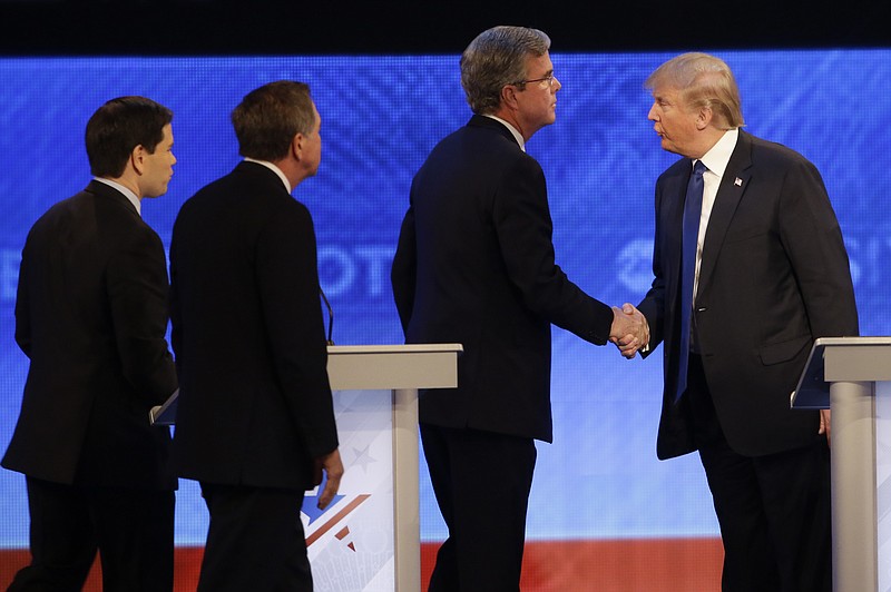 Republican presidential candidate, businessman Donald Trump shakes hands with Republican presidential candidate, former Florida Gov. Jeb Bush as Republican presidential candidate, Sen. Marco Rubio, R-Fla., and Republican presidential candidate, Ohio Gov. John Kasich walk past after a Republican presidential primary debate hosted by ABC News at the St. Anselm College Saturday, Feb. 6, 2016, in Manchester, N.H. 