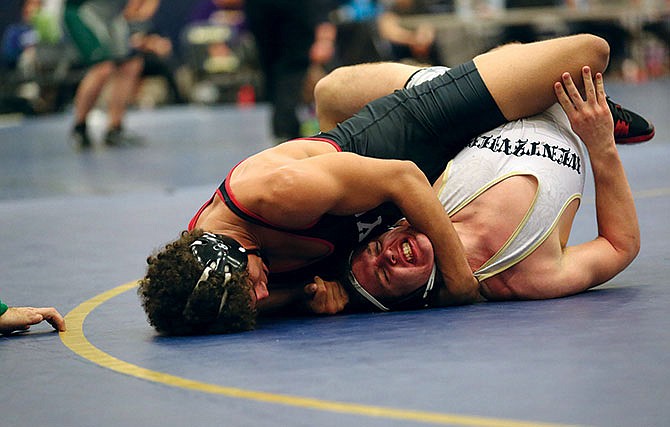 Jalen Martin of Jefferson City works his Wentzville Holt opponent onto his back during their match Saturday in Columbia.