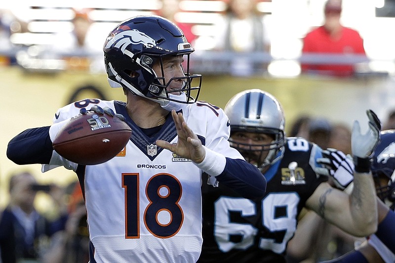 Denver Broncos' Peyton Manning (18) throws a pass during the first half of the NFL Super Bowl 50 football game against the Carolina Panthers Sunday, Feb. 7, 2016, in Santa Clara, Calif. At right is Carolina Panthers Jared Allen (69). 