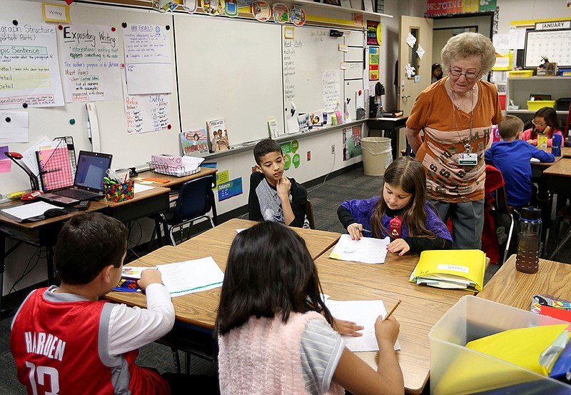 In this photo taken on Monday, Jan. 11, 2016, substitute teacher Dorothy Deck Hargrove watches third grade students illustrate a poem, at North Pointe Elementary School, in Houston. Hargrove, who is 90-years-old, has taught for more than 65 years and has no plans of slowing down.